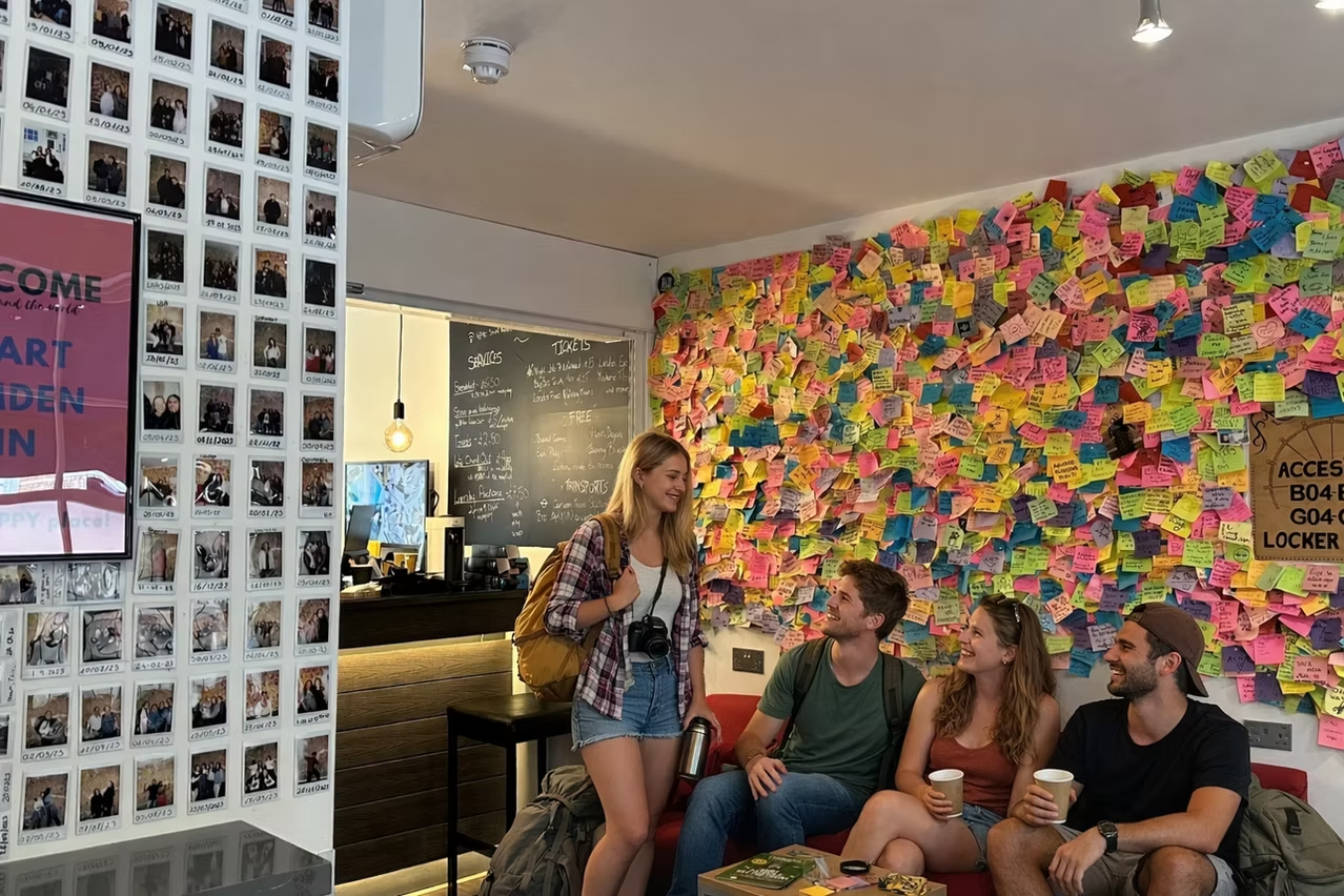 Guests relaxing beside Camden Inn's colourful message wall