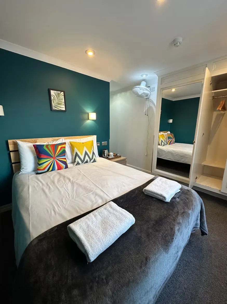 Private double room with teal accent wall