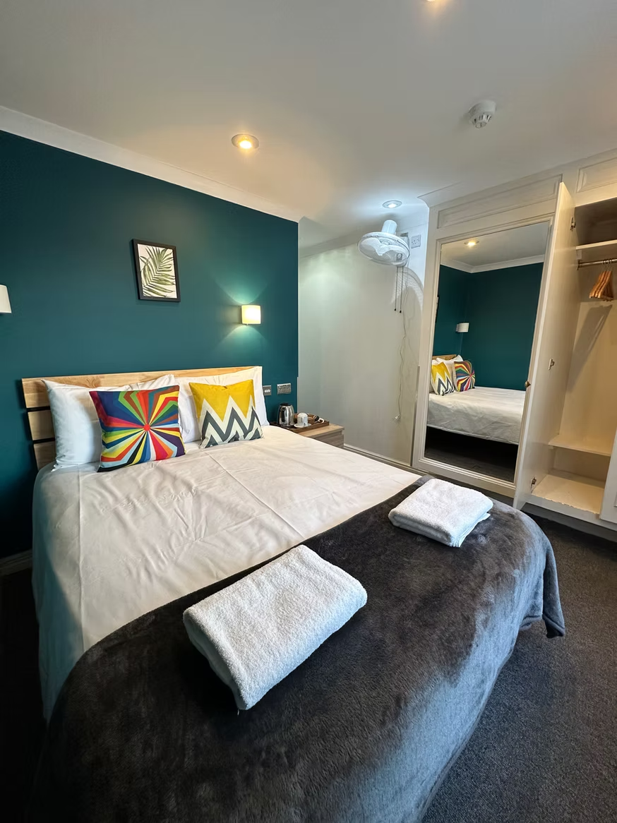 Private double room with teal accent wall
