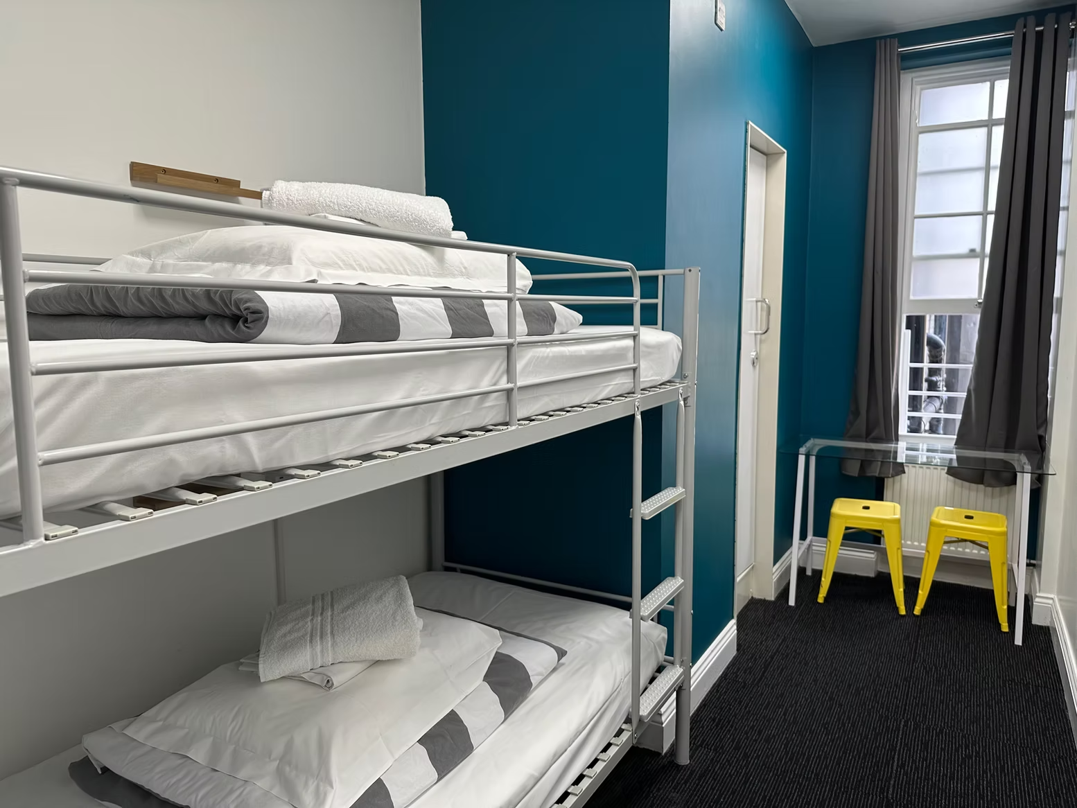 Fresh linens on twin bunks in a private room