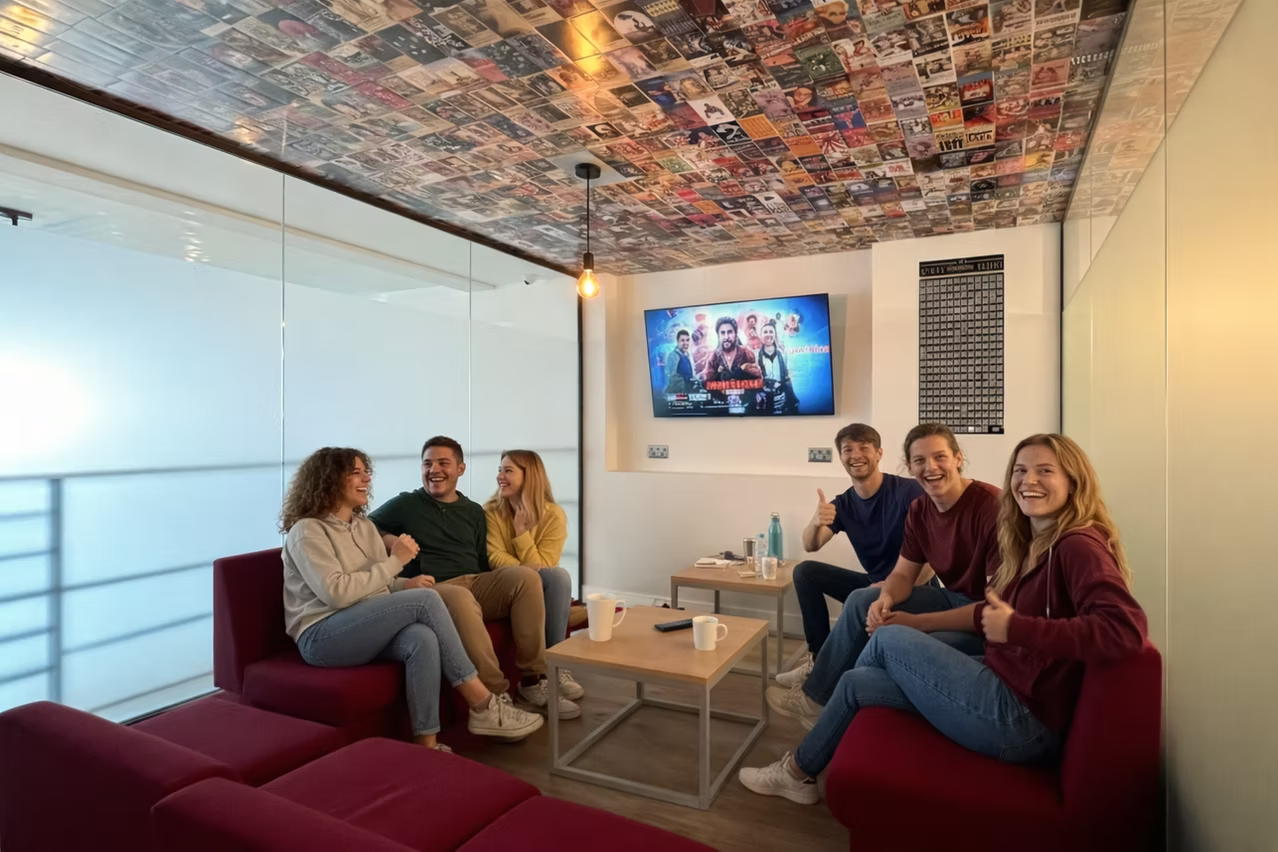 TV lounge with guests on red sofas