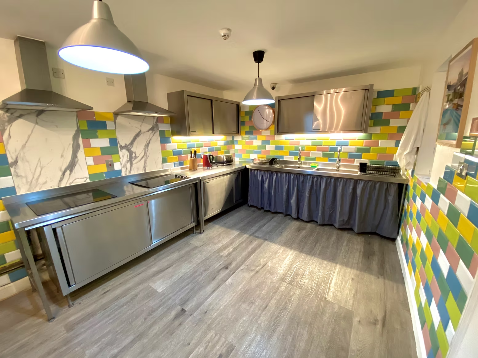 Self-catering kitchen with colourful tiled walls