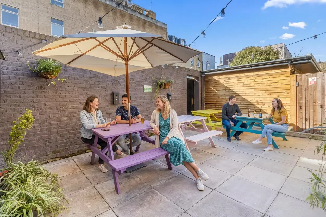 Guests relaxing in the hostel garden patio